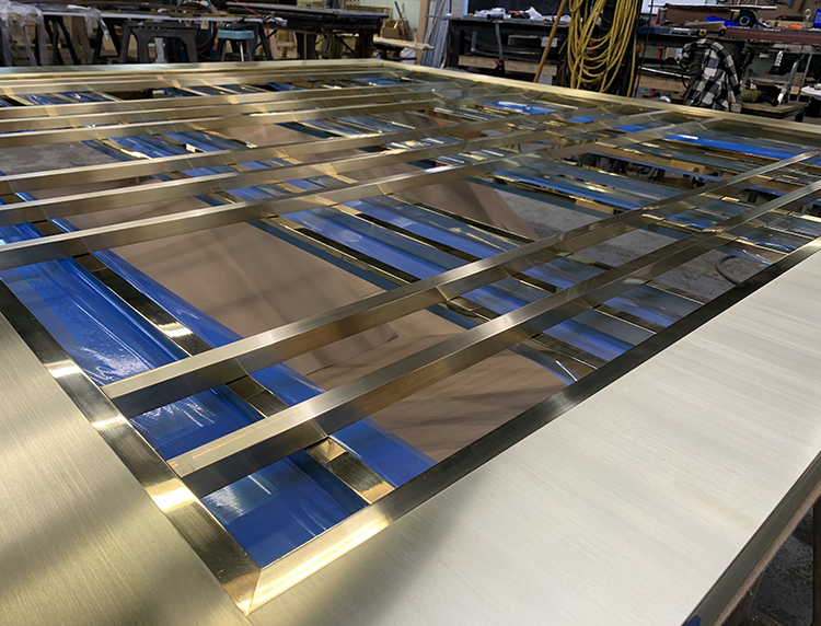 production of custom brass doors in the Magma Build Studio