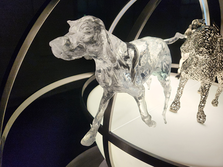 Three Graces Nickel Sculpture Featured Image Plastic Dog Detail