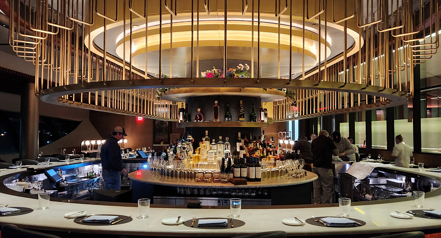 Brass and bronze installation above an airport bar lounge